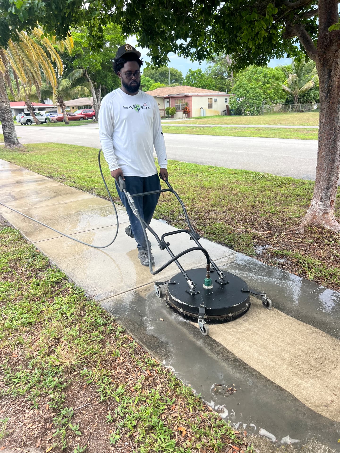 Pressure washing a neighborhood sidewalk with a surface cleaner