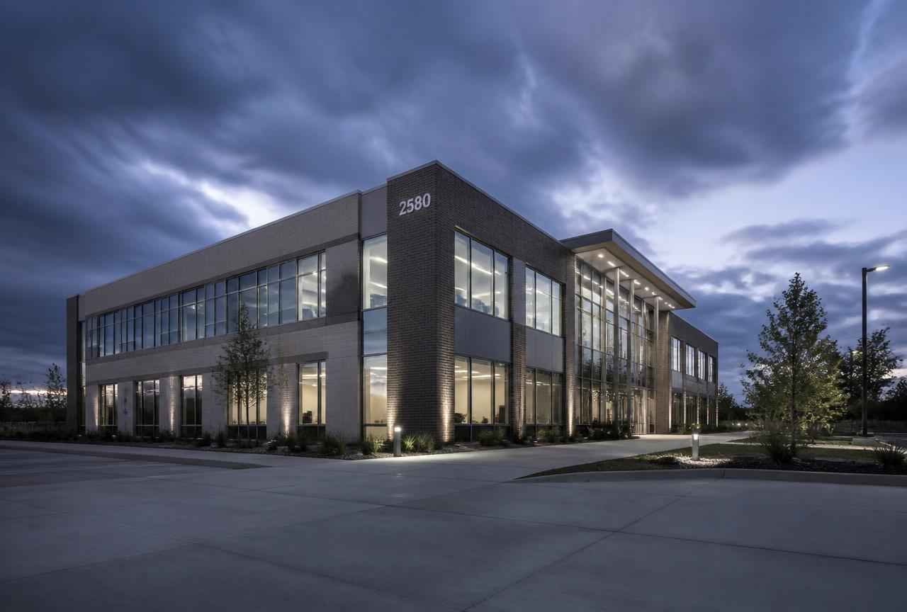 Modern commercial building exterior with clean walkways at dusk